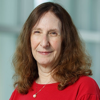 Image of Ellen Smith wearing a red shirt, looking at the camera.